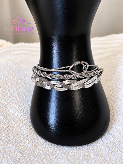 Silver Trinity Luxe Bracelet Trio displayed on a black bracelet stand