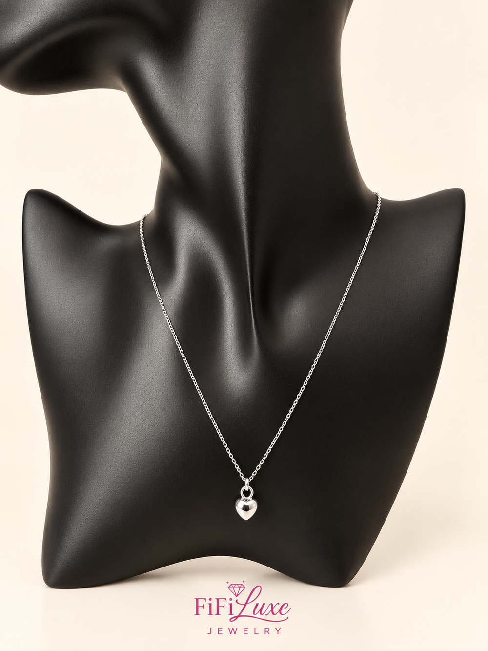 variant: Silver | Apple Belle Necklace, silver heart pendant styled on black display