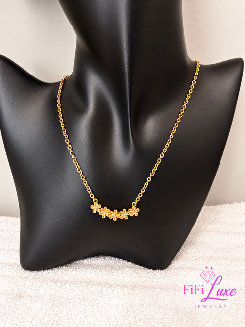 variant: Gold | Flora Charm Necklace, front view with gold flowers on black bust